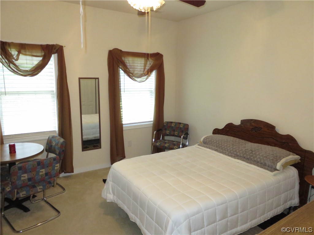 4740 Southmoor Road Richmond, VA 23234 - Photo 41 of 42 a bedroom with a bed and dresser with mirror