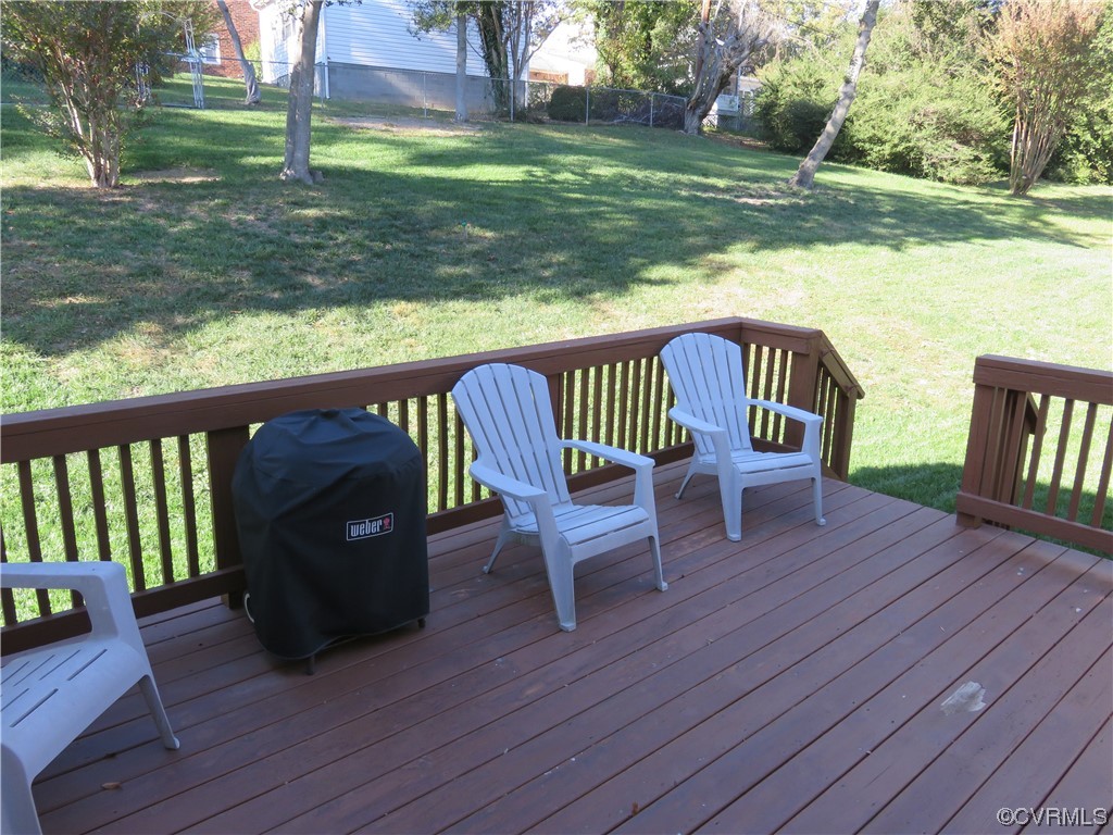 4740 Southmoor Road Richmond, VA 23234 - Photo 8 of 42 a view of a deck with a table and chairs with wooden floor next to a yard