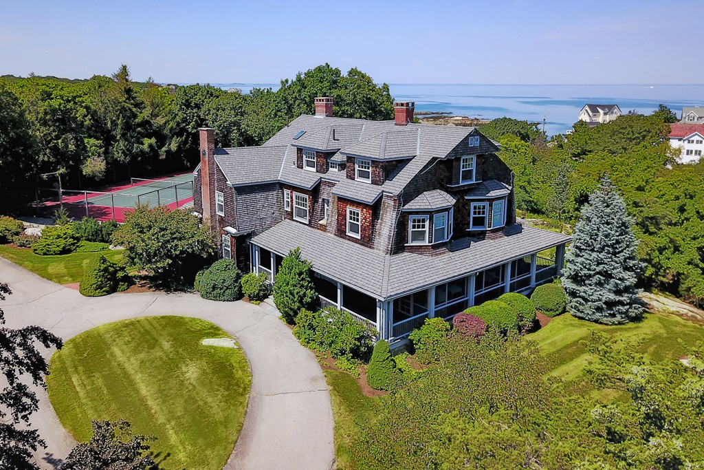 an aerial view of a house with a big yard and large trees