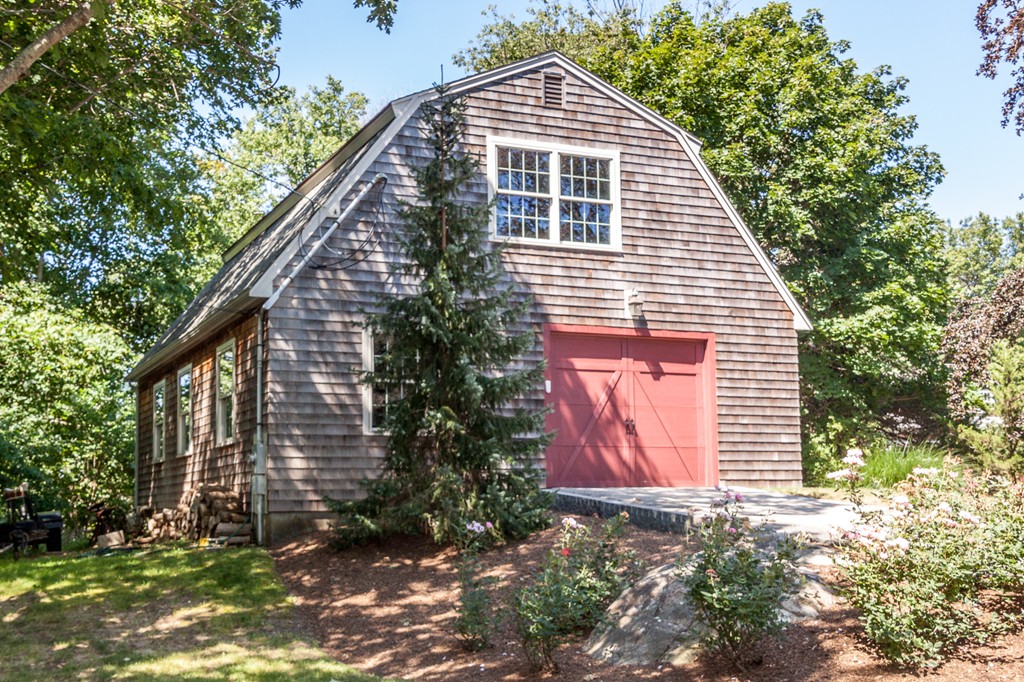 100 Nichols Road Cohasset, MA 02025 - Photo 11 of 30 a front view of a house with a garden