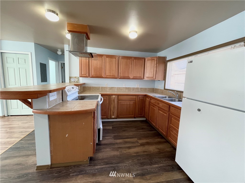2804 Northeast 7th Street Renton, WA 98056 - Photo 7 of 29 a kitchen with stainless steel appliances granite countertop a sink stove and refrigerator