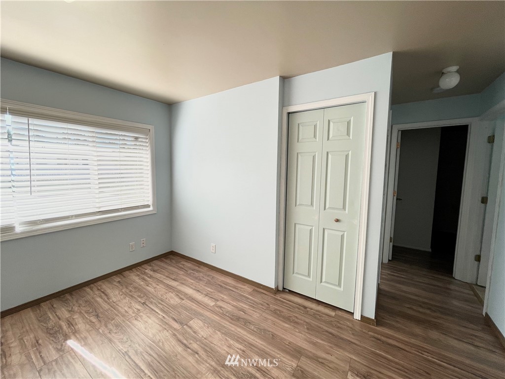 2804 Northeast 7th Street Renton, WA 98056 - Photo 8 of 29 a view of an empty room with wooden floor and a window