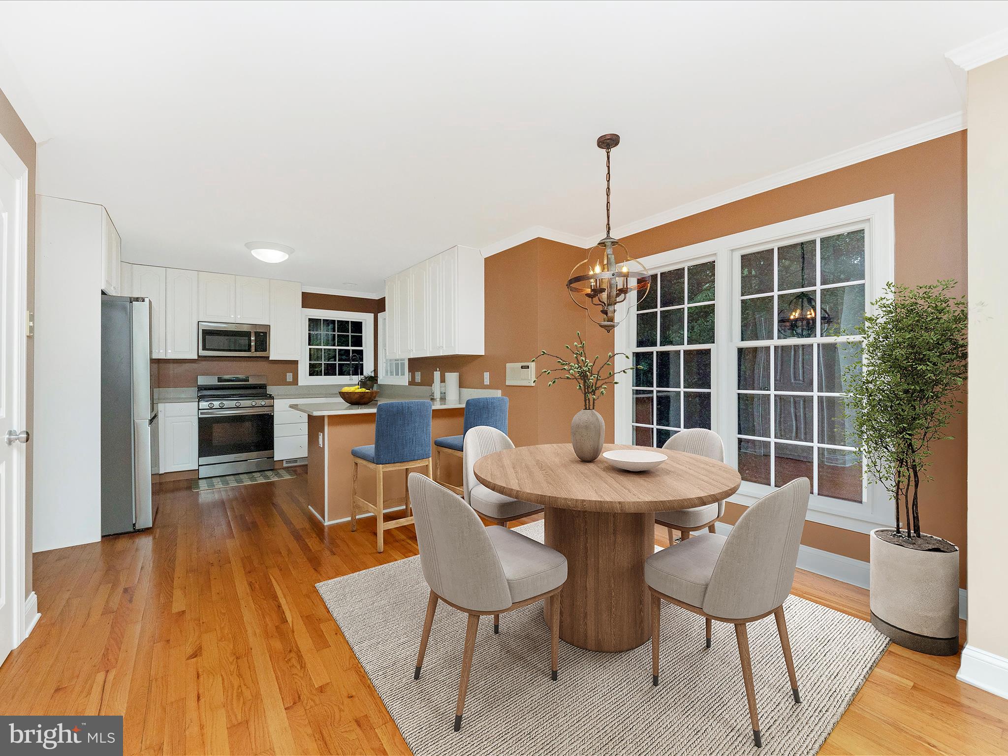2668 Ogleton Road Annapolis, MD 21403 - Photo 13 of 51 a dining room with furniture a rug and wooden floor