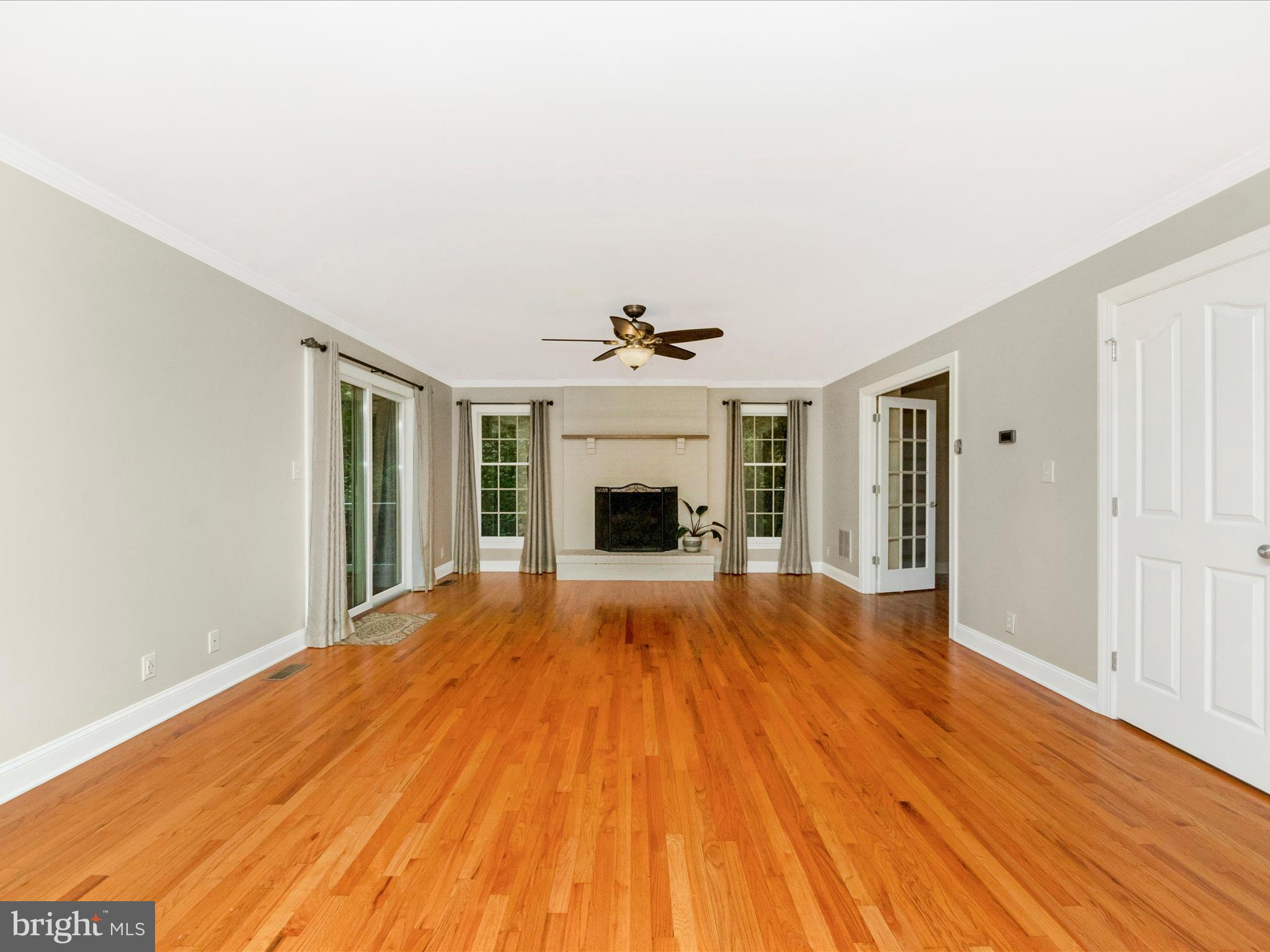 2668 Ogleton Road Annapolis, MD 21403 - Photo 16 of 51 a view of an empty room with wooden floor and a fireplace