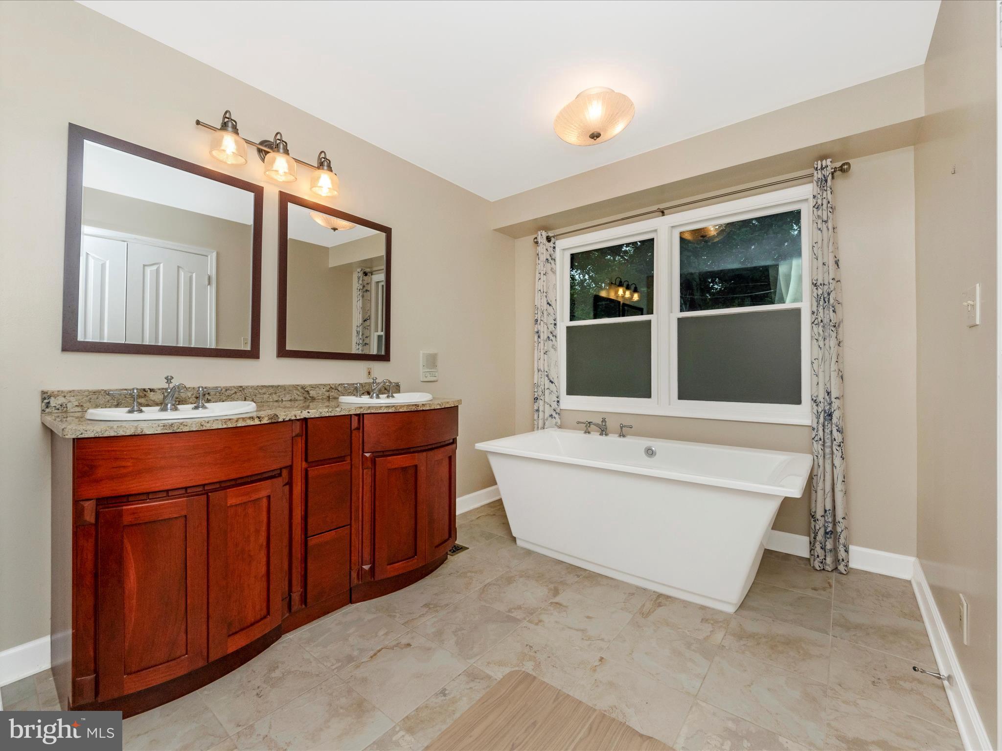 2668 Ogleton Road Annapolis, MD 21403 - Photo 25 of 51 a bathroom with a granite countertop sink and mirror with bathtub
