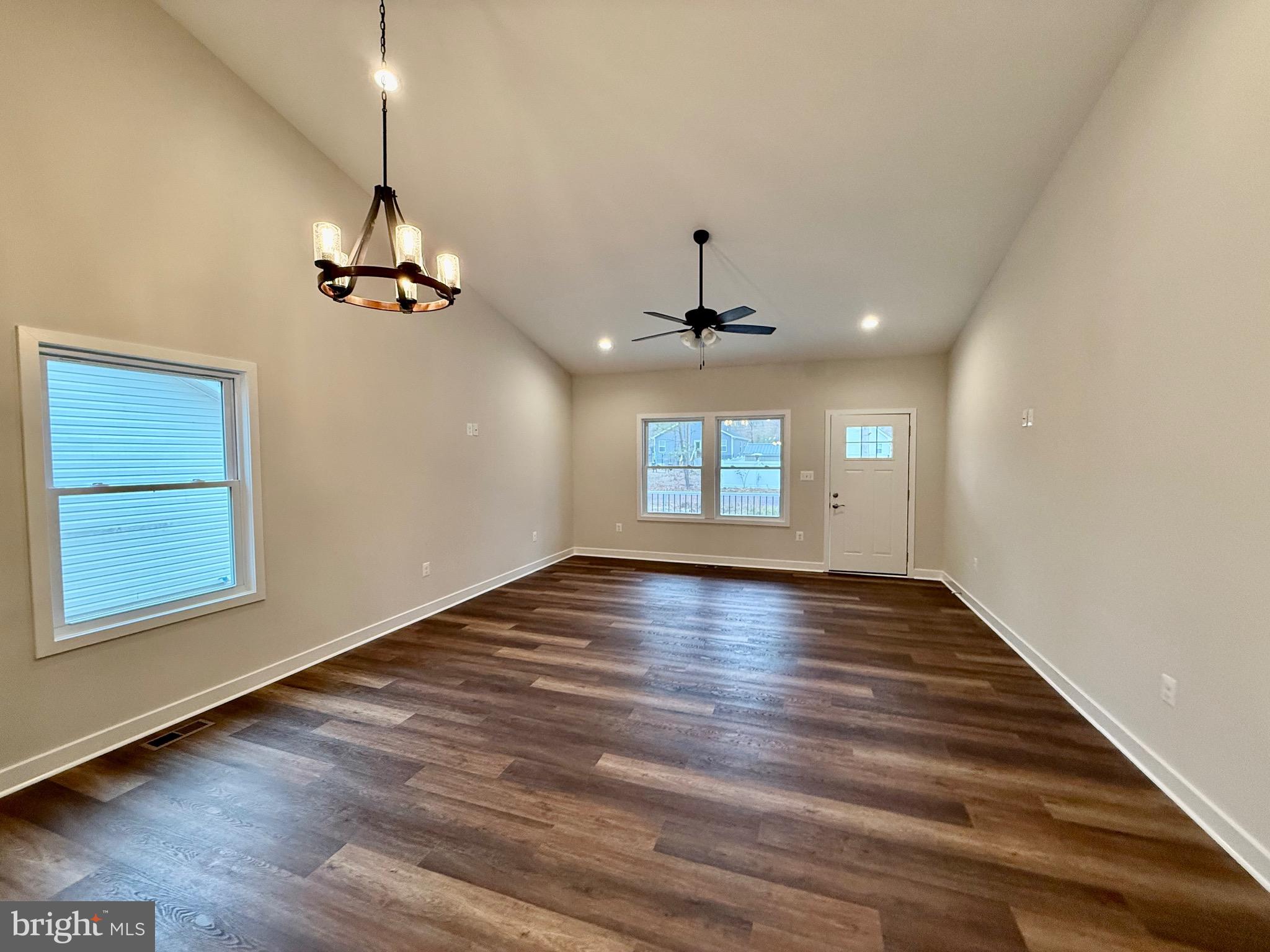 130 Poplar Lane Colonial Beach, VA 22443 - Photo 13 of 74 an empty room with wooden floor chandelier and windows
