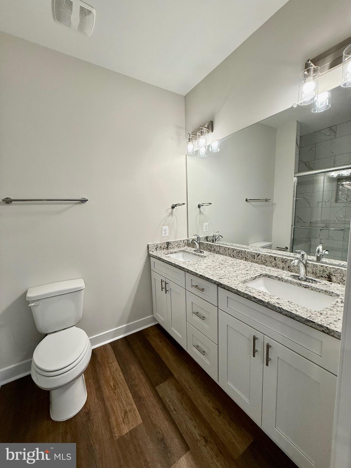 130 Poplar Lane Colonial Beach, VA 22443 - Photo 26 of 74 a bathroom with a granite countertop toilet sink and mirror