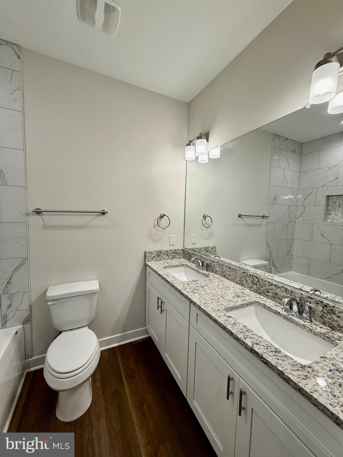 130 Poplar Lane Colonial Beach, VA 22443 - Photo 29 of 74 a bathroom with a granite countertop sink a toilet and a mirror