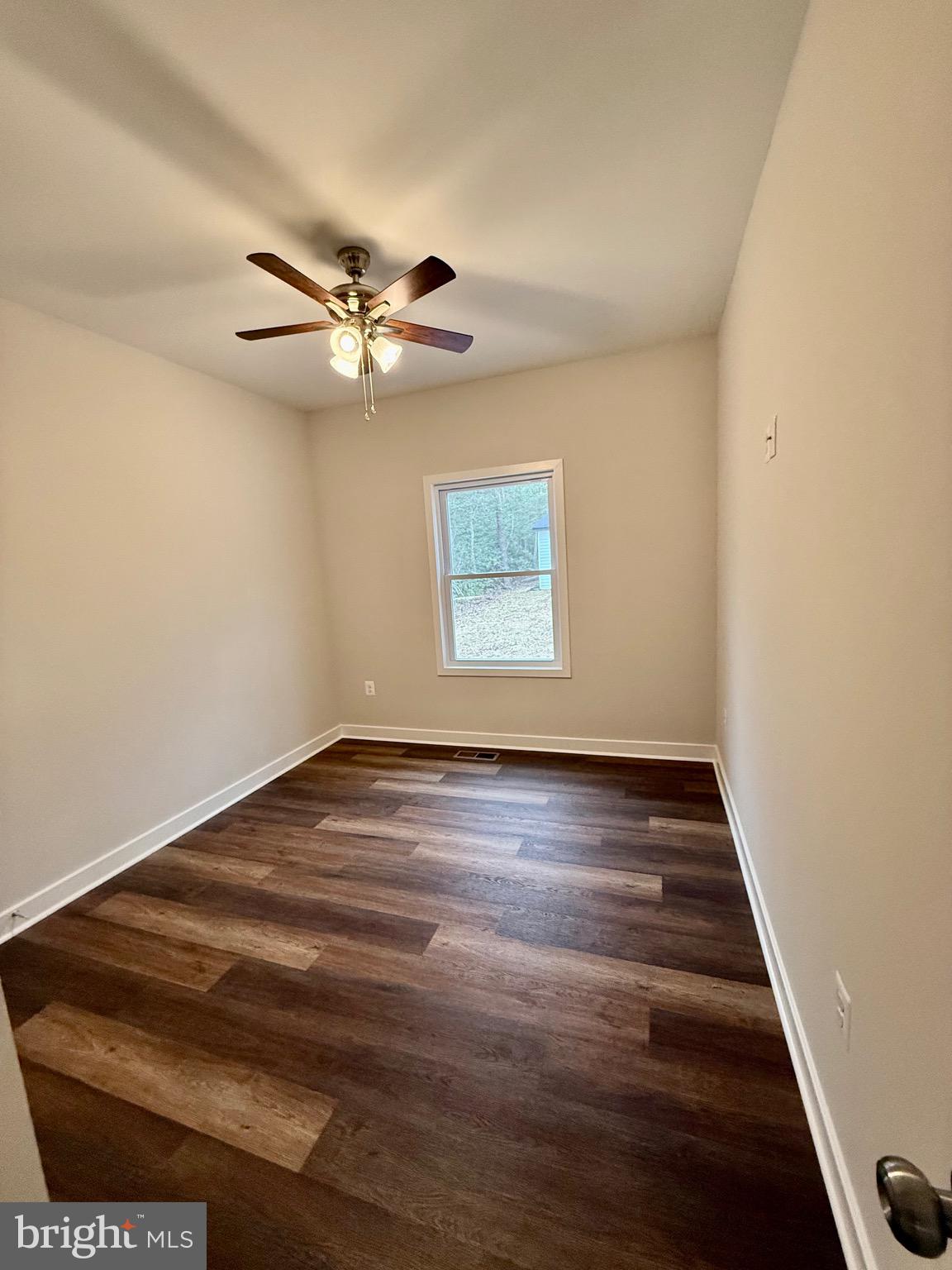 130 Poplar Lane Colonial Beach, VA 22443 - Photo 31 of 74 an empty room with wooden floor ceiling fan and windows