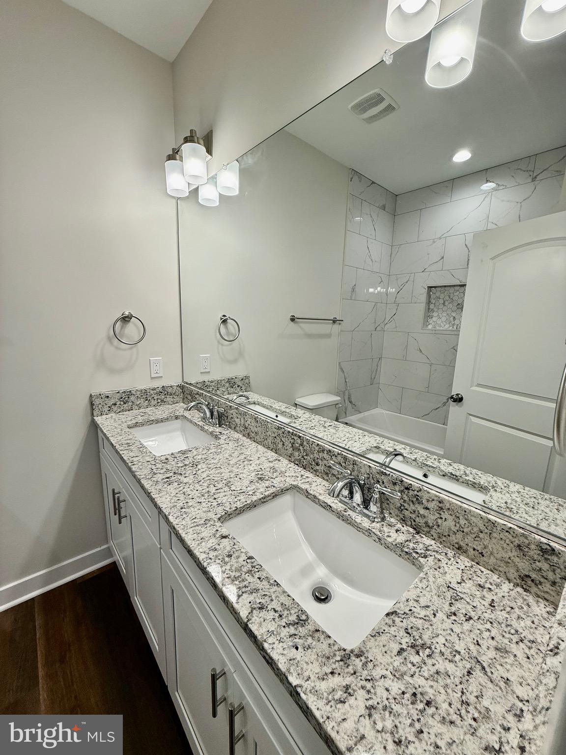 130 Poplar Lane Colonial Beach, VA 22443 - Photo 36 of 74 a bathroom with a granite countertop sink a large mirror and a shower