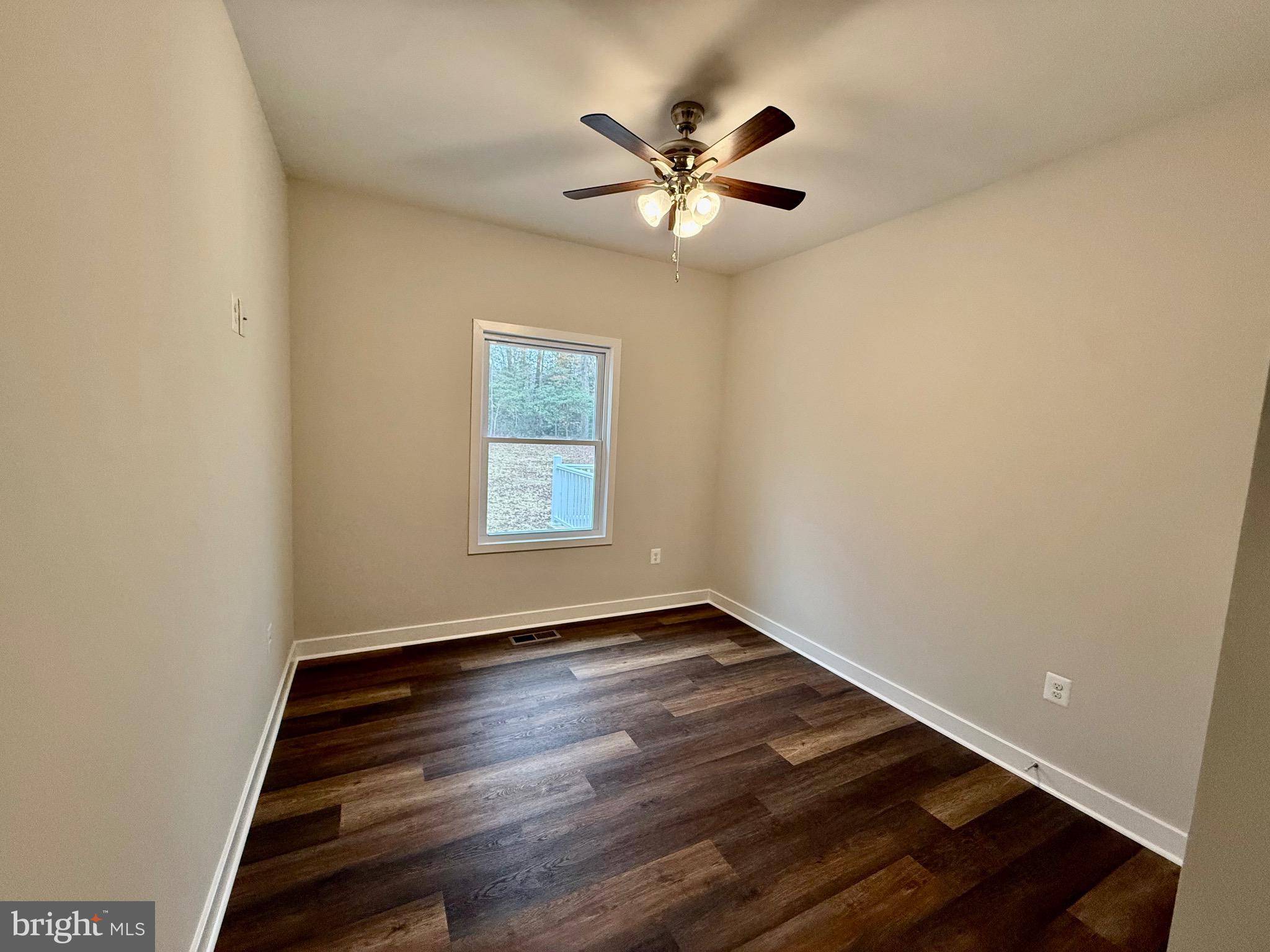130 Poplar Lane Colonial Beach, VA 22443 - Photo 37 of 74 an empty room with wooden floor fan and windows