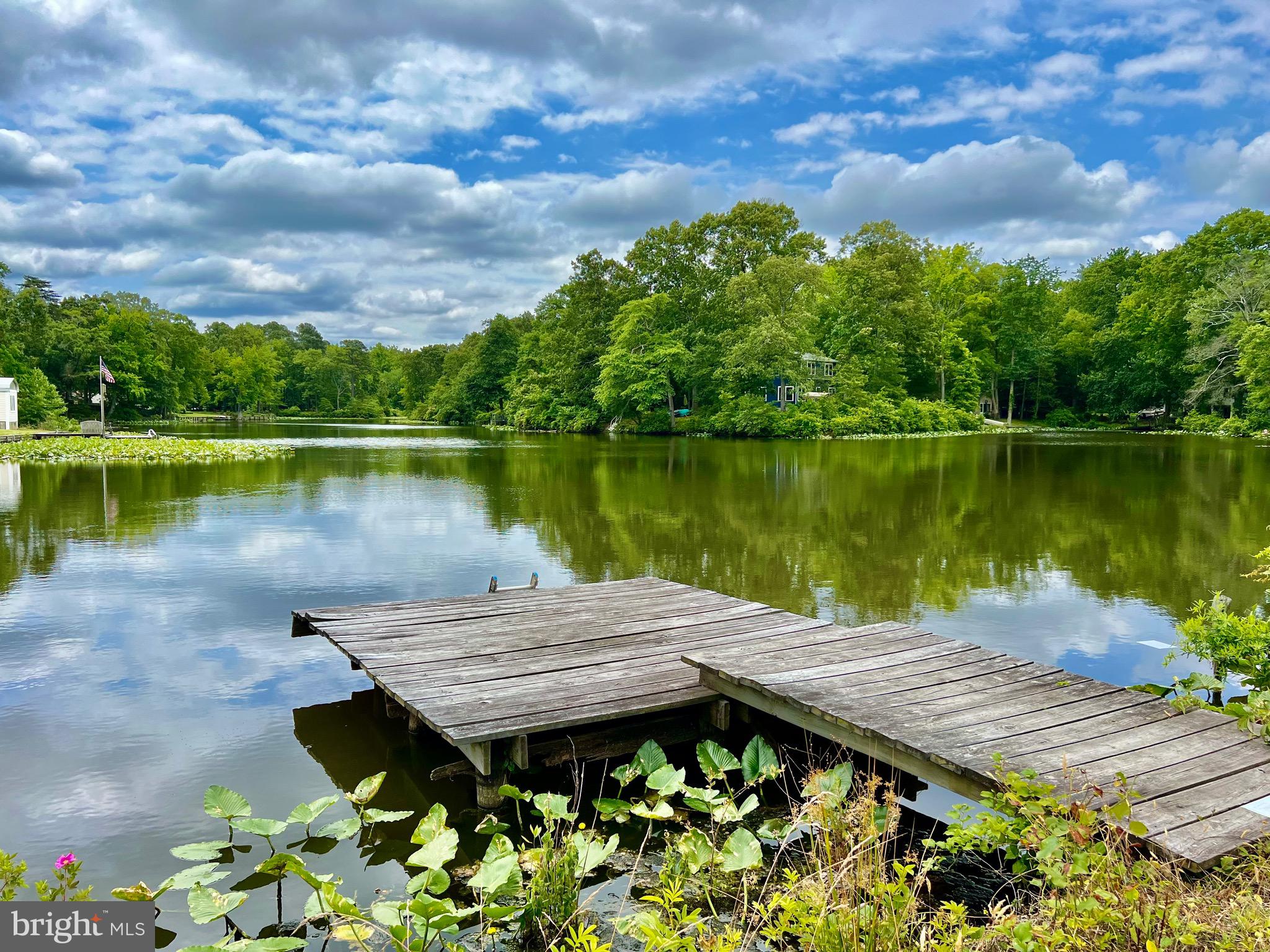 130 Poplar Lane Colonial Beach, VA 22443 - Photo 42 of 74 a wooden bench sitting next to a lake
