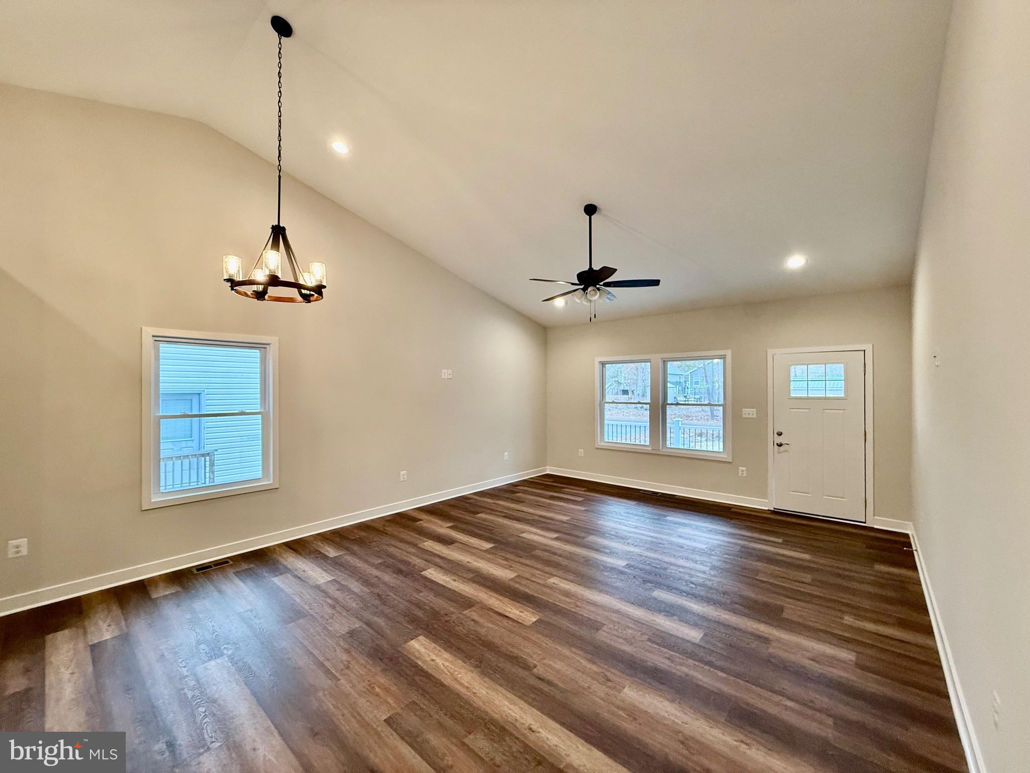 130 Poplar Lane Colonial Beach, VA 22443 - Photo 8 of 74 a view of empty room with wooden floor and ceiling fan