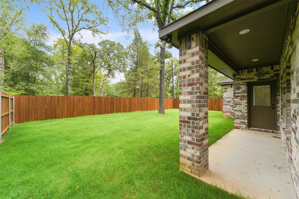 122 East Beachwood Loop Trinidad, TX 75163 - Photo 33 of 35 Expansive backyard featuring a lush lawn and wood privacy fencing