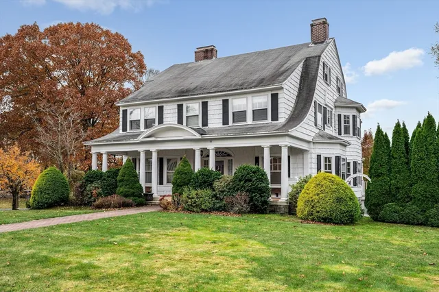 a front view of a house with a garden