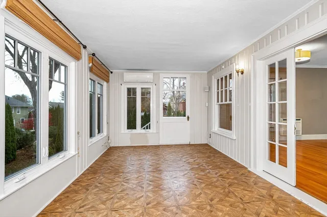 a view of an entryway with wooden floor and garden