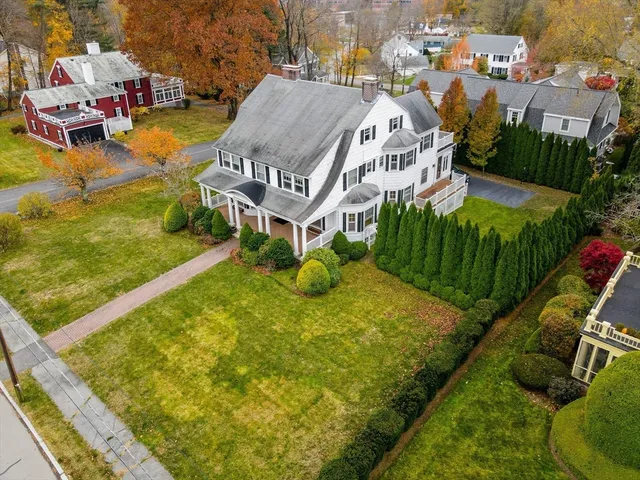 a aerial view of a house with swimming pool and ocean view