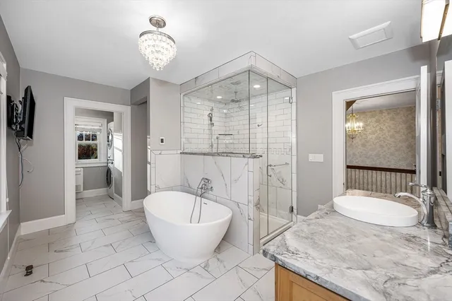 a spacious bathroom with a granite countertop sink a toilet a mirror and shower