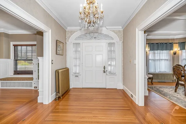 a view of a livingroom with wooden floor and a chandelier
