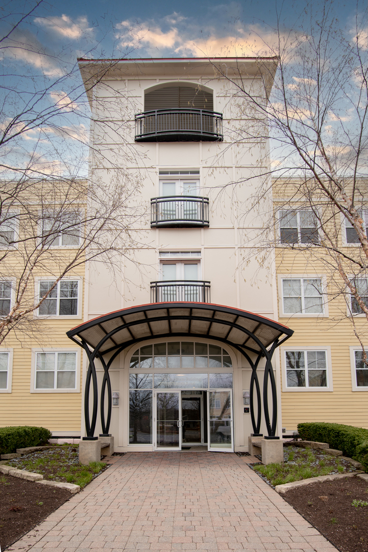 977 Harris Road, Unit 14 Grayslake, IL 60030 - Photo 1 of 21 a front view of a house with a garden