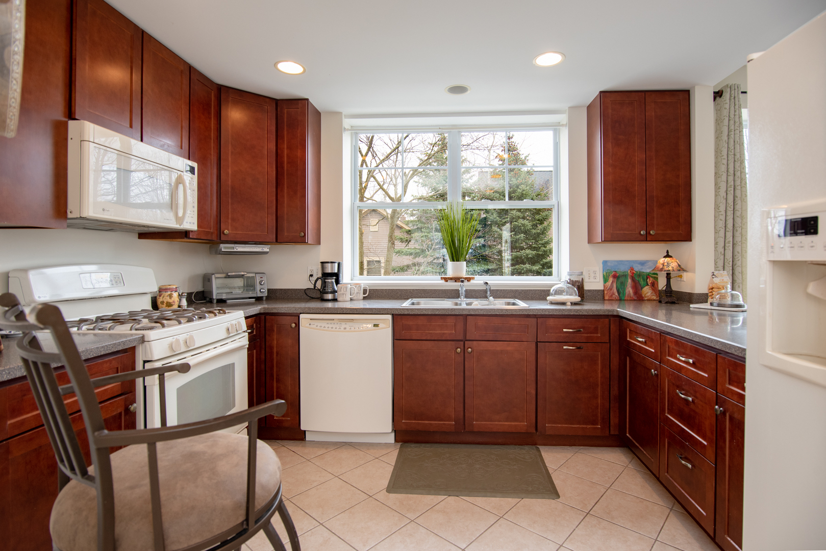 977 Harris Road, Unit 14 Grayslake, IL 60030 - Photo 8 of 21 a kitchen with stainless steel appliances granite countertop wooden cabinets a sink and a stove