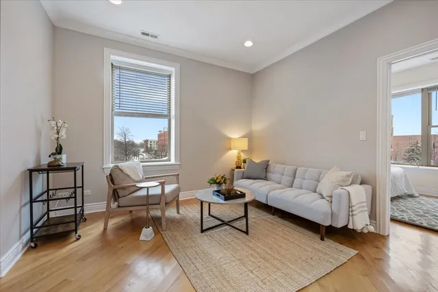 a living room with furniture a rug and a window