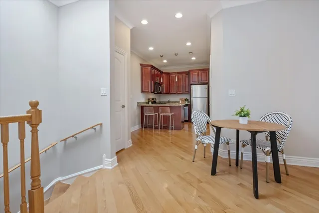 a view of a dining room with furniture and wooden floor