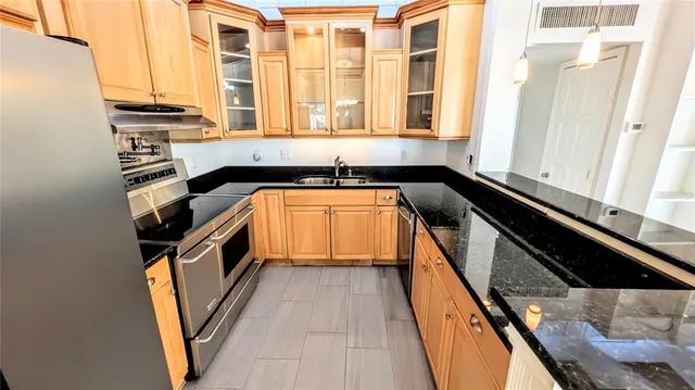 a view of a kitchen with a sink and cabinets