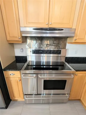 a stove top oven sitting inside of a kitchen