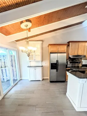 a kitchen with stainless steel appliances a refrigerator and a stove