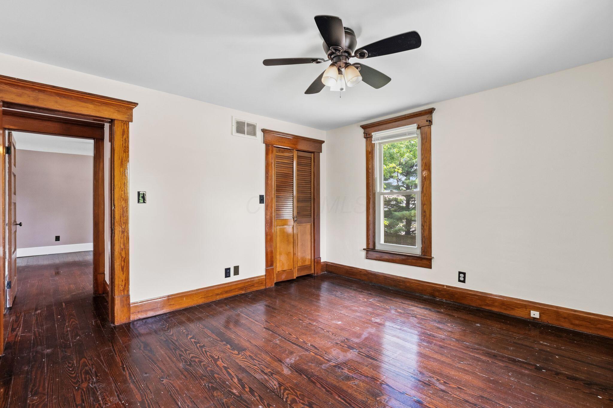 107 Price Road Columbus, OH 43230 - Photo 27 of 51 Room featuring rich wood-finish flooring, white walls, and a ceiling fan with integrated lighting