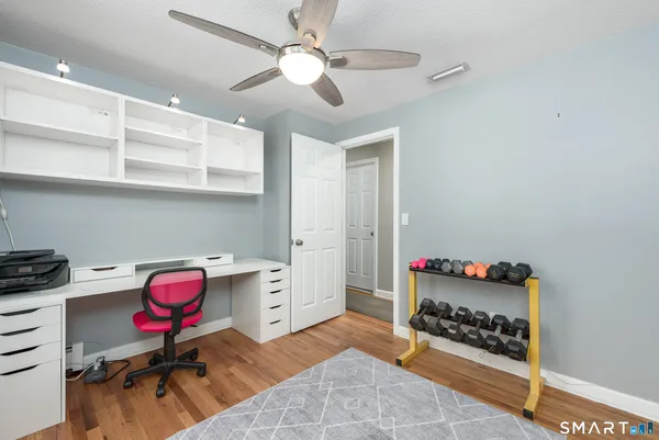 a bedroom with furniture and gym equipment