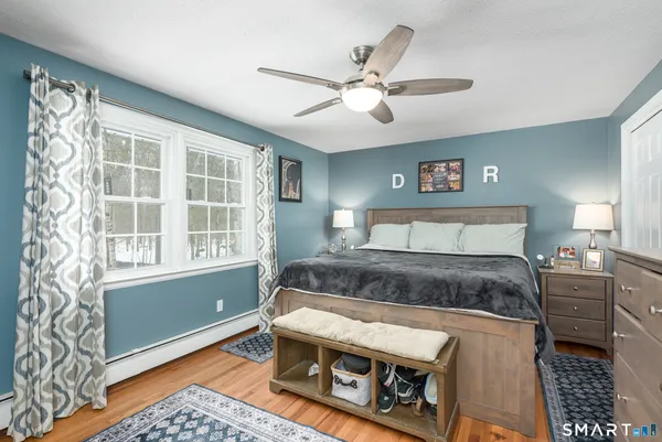 a spacious bedroom with a bed and a window