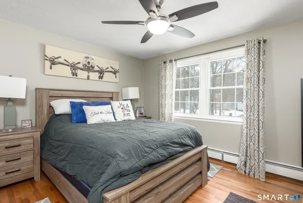 a bedroom with a bed and a window