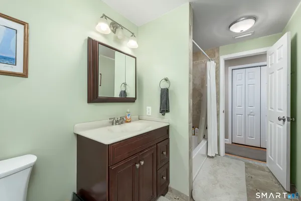 a bathroom with a toilet sink and mirror