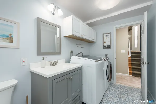 a utility room with a sink a washer and dryer