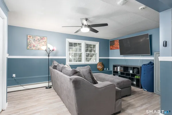 a living room with furniture a fireplace and a flat screen tv