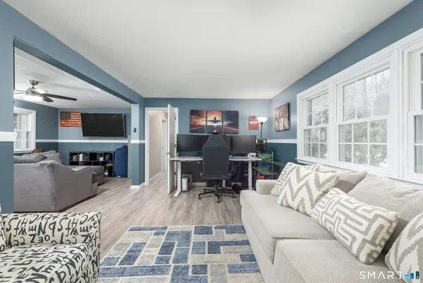 a living room with furniture and a flat screen tv