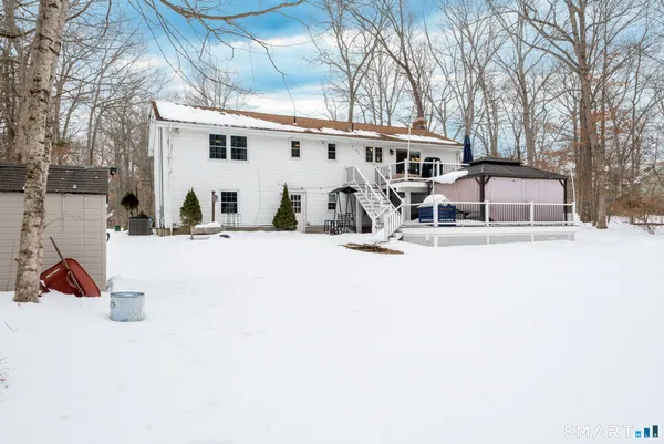 a view of a house with snow on the road