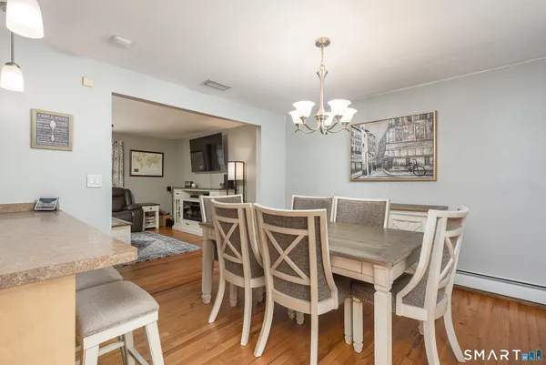 a view of a dining room with furniture and wooden floor