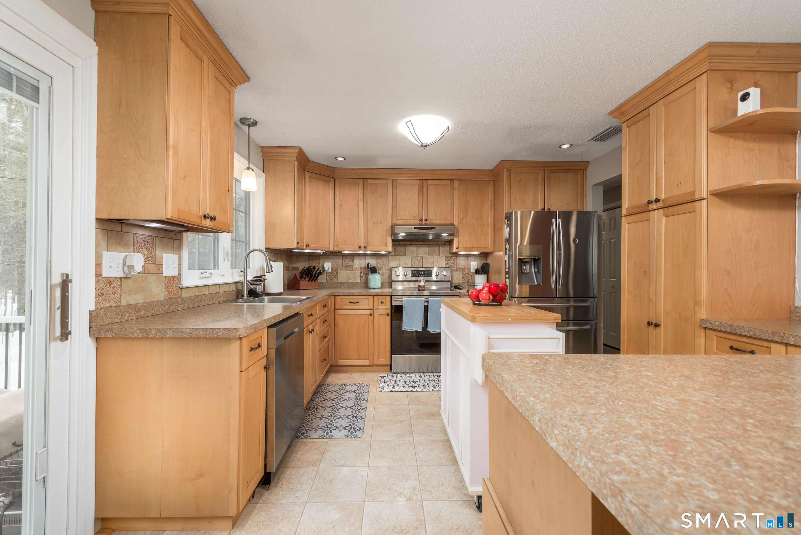 33 Northam Road Hebron, CT 06231 - Photo 8 of 36 a kitchen with kitchen island a counter top space a sink a refrigerator and cabinets