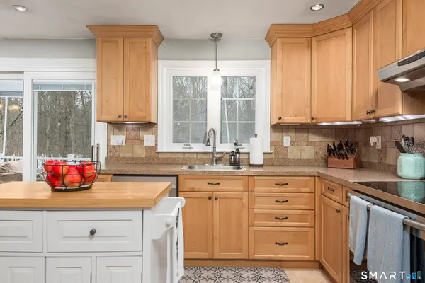 a kitchen with stainless steel appliances a sink stove and window