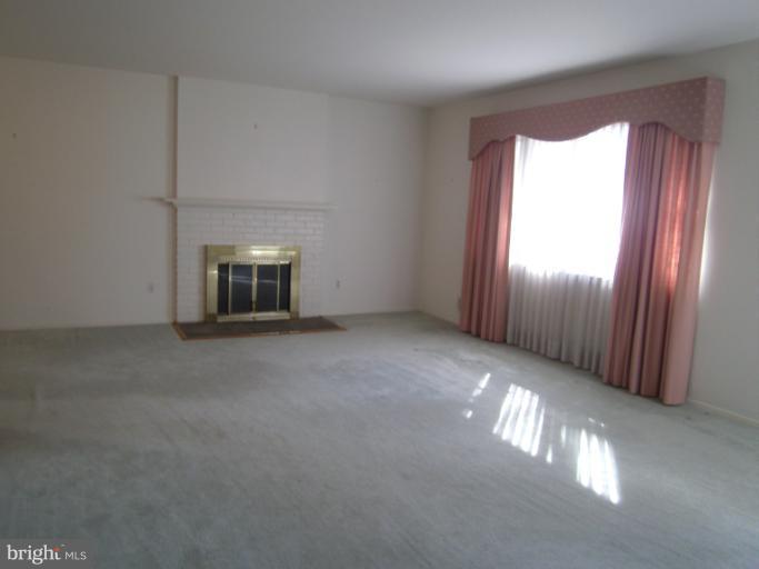 7620 Webbwood Court Springfield, VA 22151 - Photo 12 of 18 an empty room with windows and fireplace