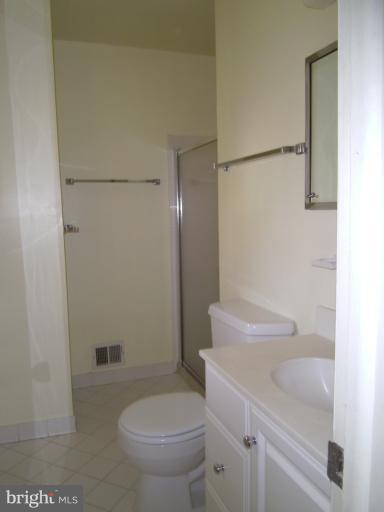 7620 Webbwood Court Springfield, VA 22151 - Photo 14 of 18 a white toilet sitting next to a bathroom sink