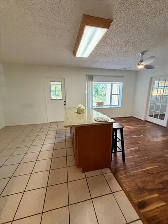 an empty room with windows and cabinet