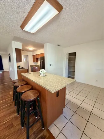 a view of kitchen with granite countertop window and white appliances