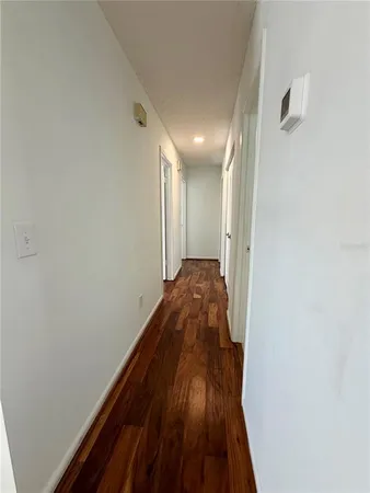 a view of hallway with wooden floor