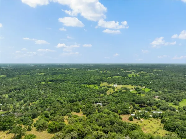 a view of a big yard with lots of green space and mountain view