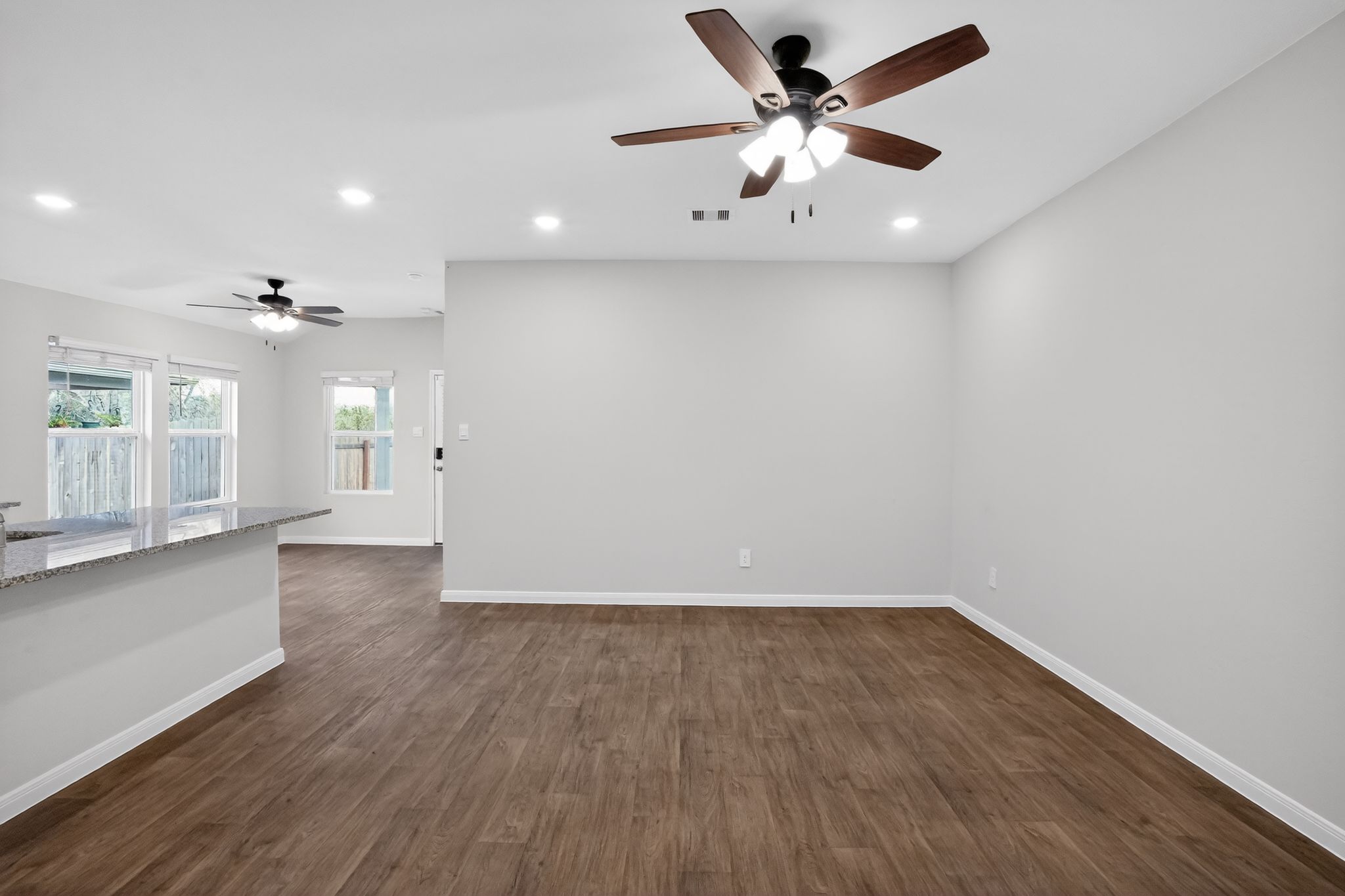 206 Addison Place Lockhart, TX 78644 - Photo 10 of 25 an empty room with wooden floor and a ceiling fan