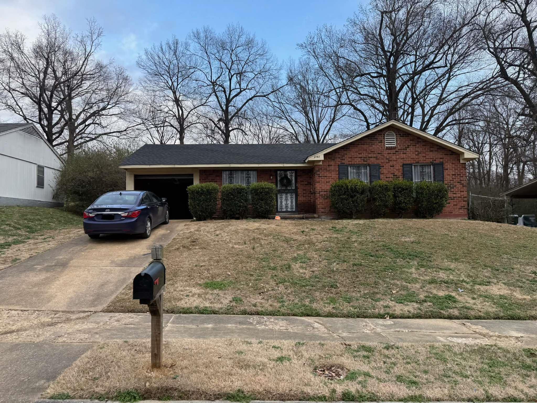 Ranch-style home with a garage and a front lawn